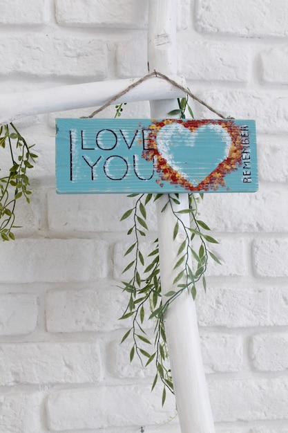 Photo wooden board with the signature love gift with a heart for valentine's day present for your beloved on february 14