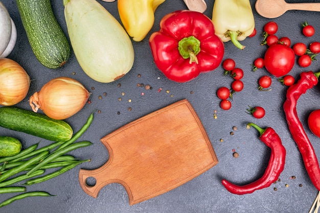Wooden board with vegetables copy space
