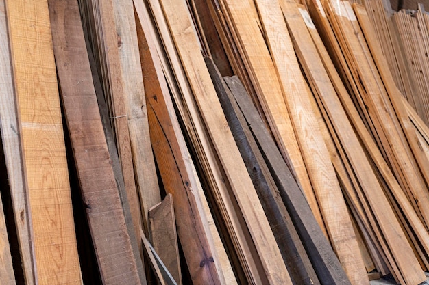 Wooden boards stored wood timber construction material for background and texture Stack of wooden