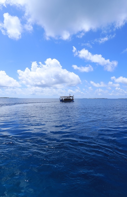 wooden boat floats on a tropical island