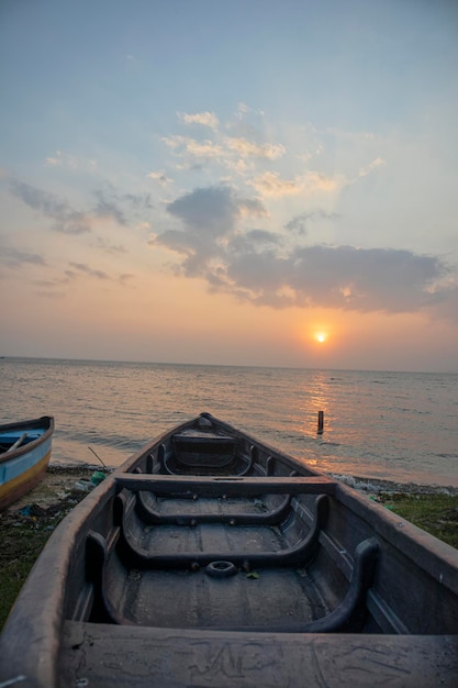 Wooden boat in the sea at sunset time Nature background