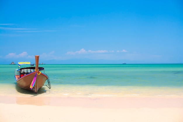 Wooden boat on a white sand beach, tropical beach in Thailand