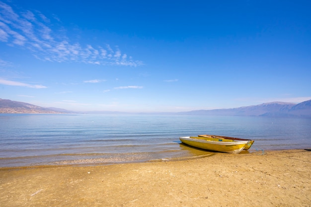 Wooden boats at pier on mountain lake.