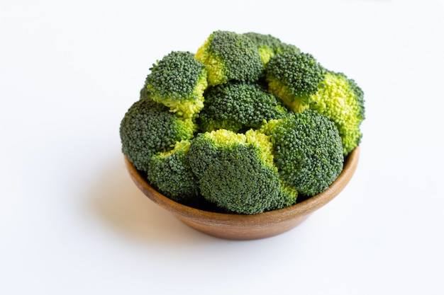 Wooden bowl of broccoli on white background