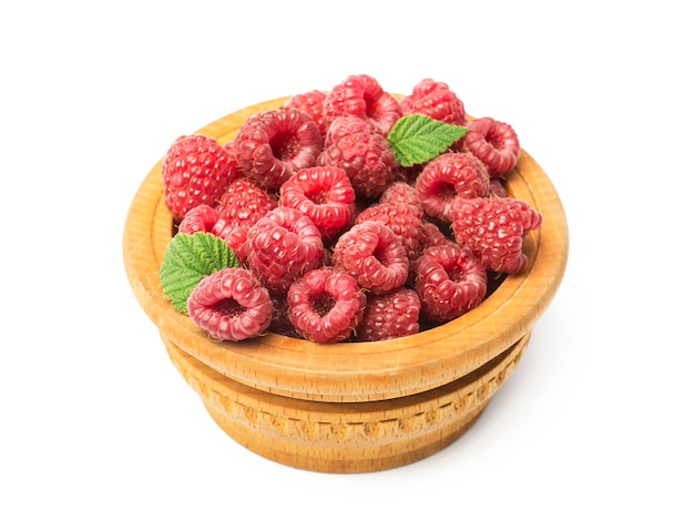 Wooden bowl full of freshly picked raspberries