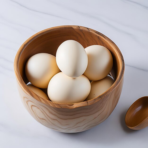 Wooden Bowl of Organic Raw Eggs on Marble Surface