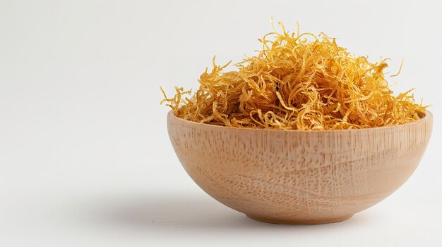 Photo a wooden bowl of saffron is shown on a white background