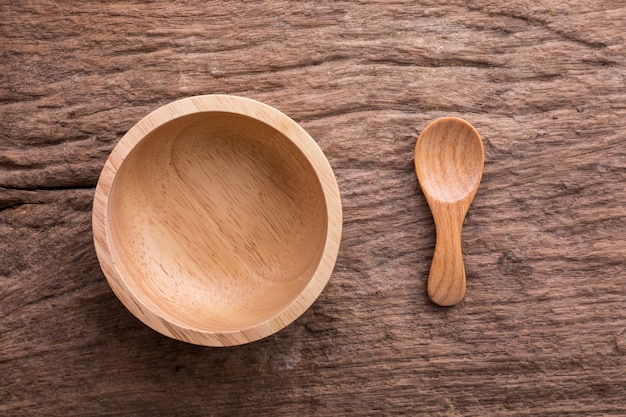 wooden bowl and spoon on wooden background