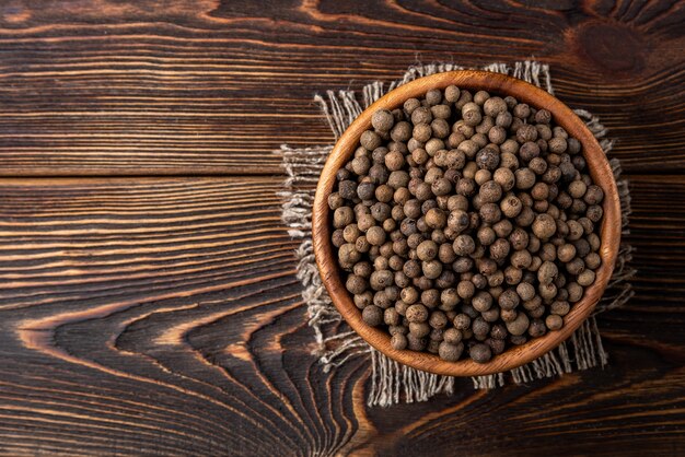 wooden bowl with black pepper