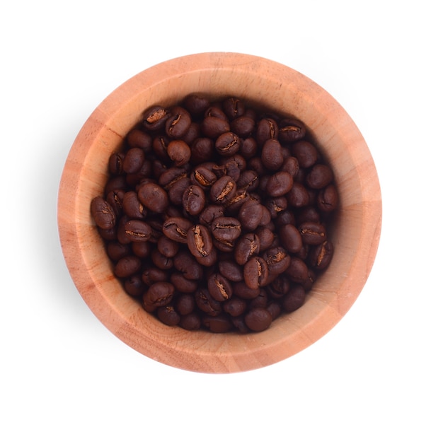 Wooden Bowl with coffee beans on white surface.