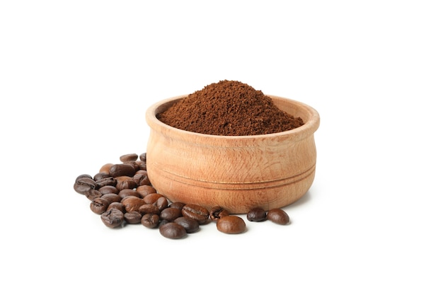 Wooden bowl with ground coffee isolated on white background