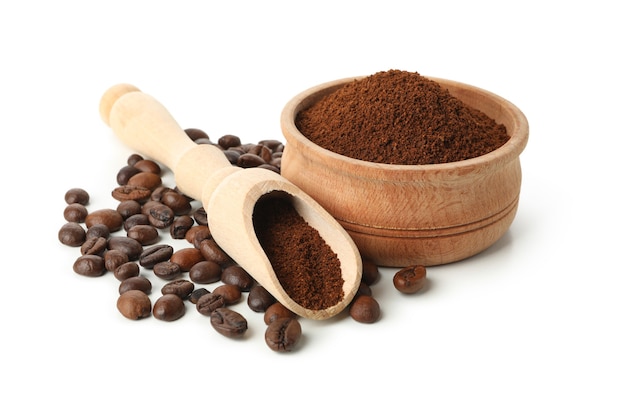 Wooden bowl with ground coffee isolated on white