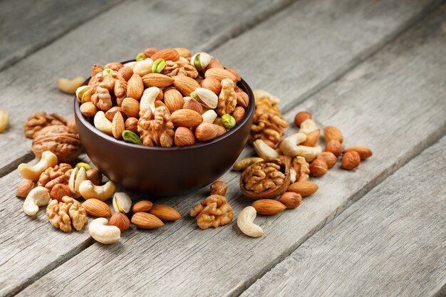 Wooden bowl with mixed nuts Walnut, pistachios, almonds, hazelnuts and cashews, walnut.