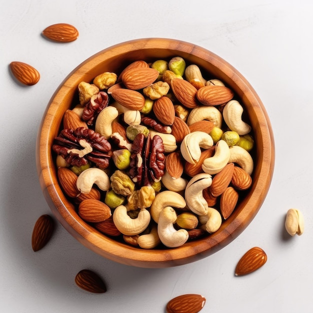 Wooden bowl with mixed nuts on white table top view Pistachios almonds and cashews Generative AI