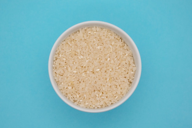 Wooden bowl with parboiled rice