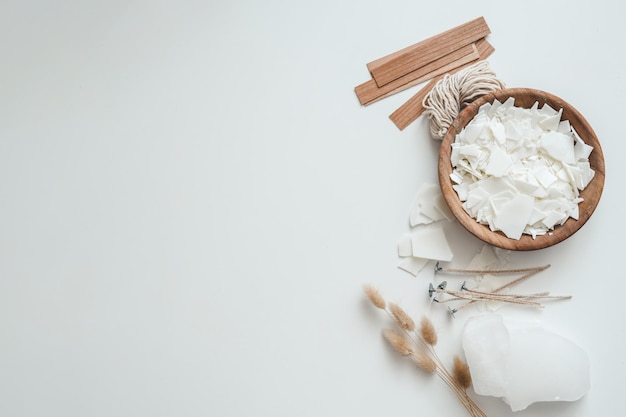 Wooden bowl with soy wax and wooden wicks candle making place for text