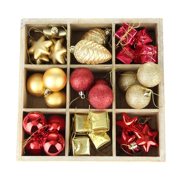 Wooden box filled with christmas decorations, isolated on white