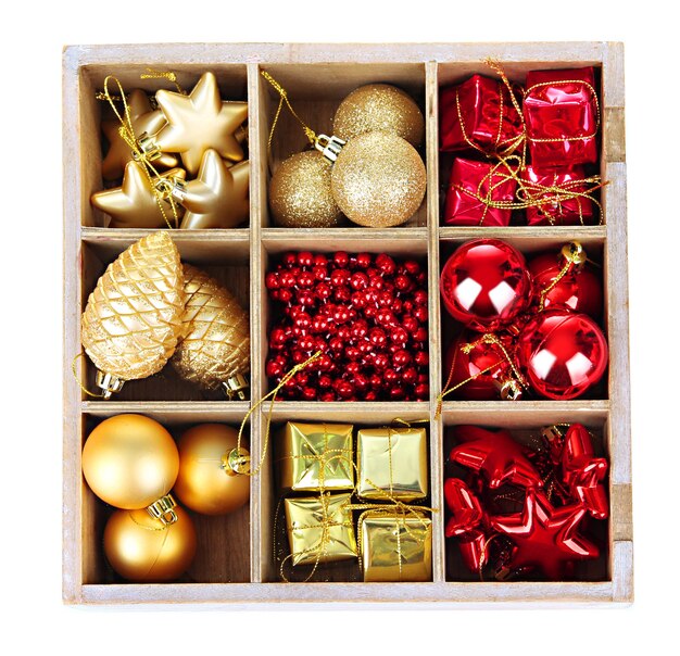 Wooden box filled with christmas decorations, isolated on white