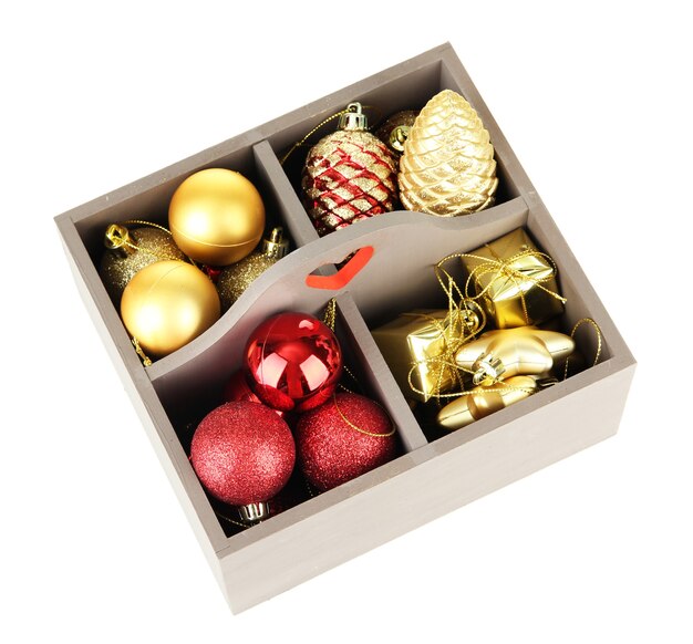 Wooden box filled with christmas decorations, isolated on white