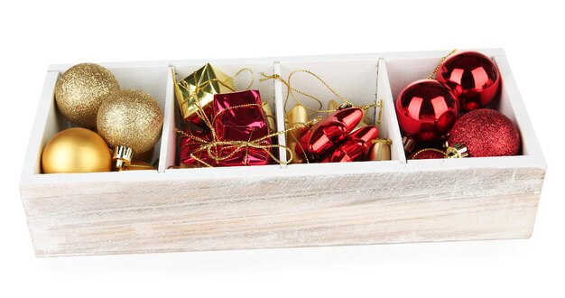 Wooden box filled with christmas decorations, isolated on white