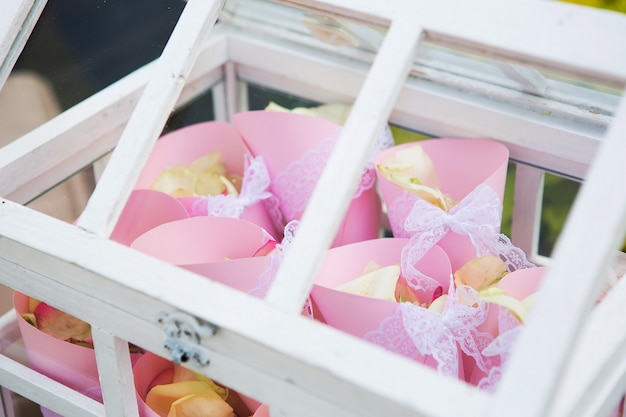 The wooden box filled with rose petals outdoors ancient style