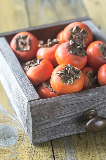 Wooden box of fresh persimmons