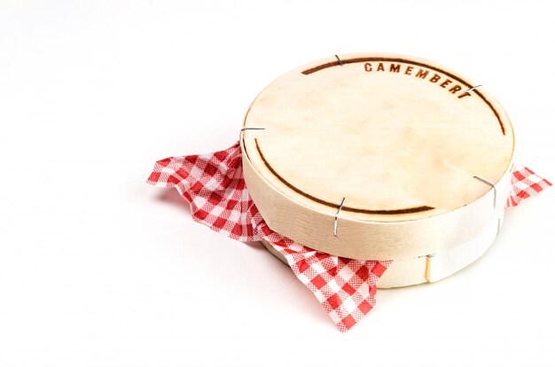 Photo wooden box with camembert cheese on white