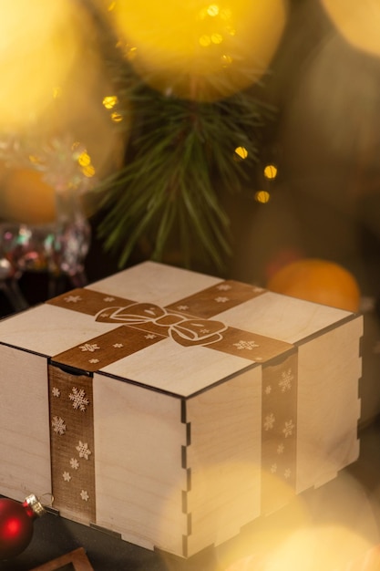 Photo wooden box with an engraving of a bow and ribbon on the lid