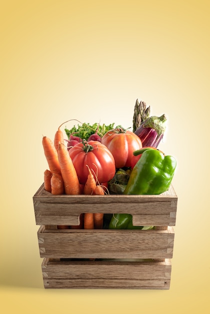 Wooden box with fresh vegetables isolated