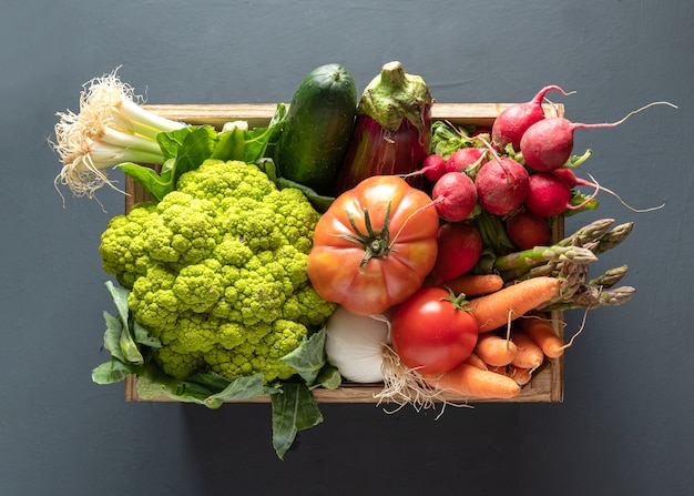 Wooden box with vegetables, high view