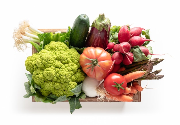 Wooden box with vegetables isolated from the white background, top view