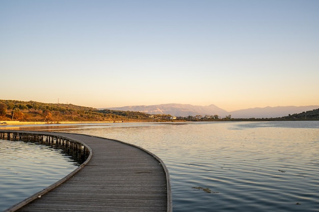 Wooden bridge is leading to the island of Zvernec in Albania nearby Narta Lagoon