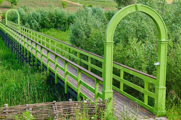 Wooden bridge in a park over a pond