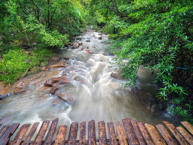 Wooden bridge over the waterfall