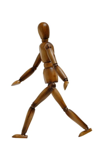 Wooden brown mannequin in walking pose white background isolate