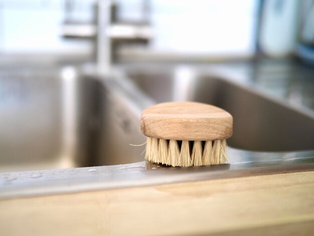 wooden brush cleaning the sink and dishes in the kitchen