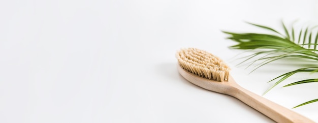 Wooden brush for dry anti cellulite massage body on white background banner copy space for text