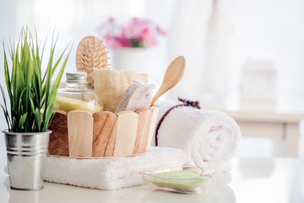 Wooden bucket with SPA accessories on white table