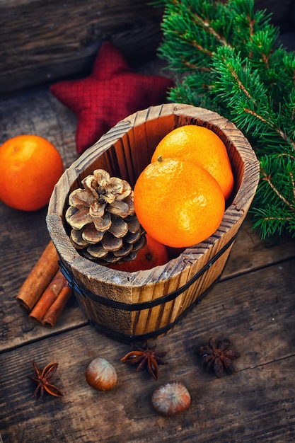 Wooden bucket with tangerines