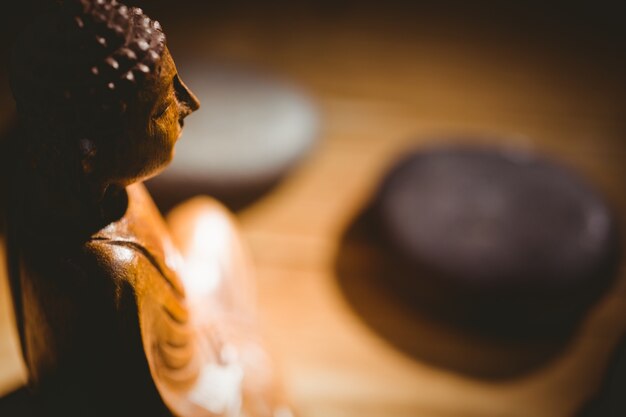 Wooden buddha statue on table