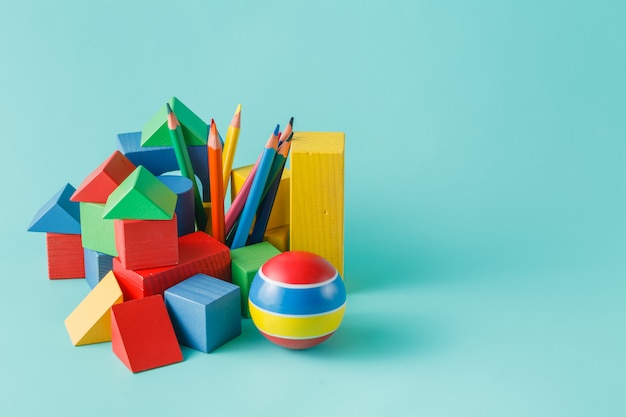 Wooden building block and colored pencils