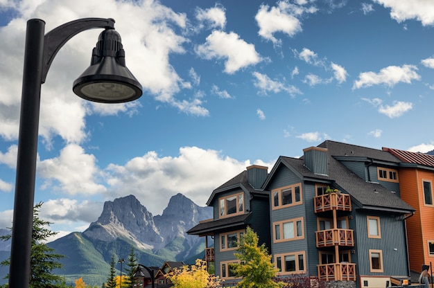 Wooden buildings with rocky mountains and street light in downtown at Canmore, Canada