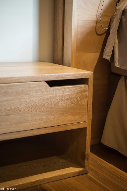 Wooden bureau on top of a rug side table night table