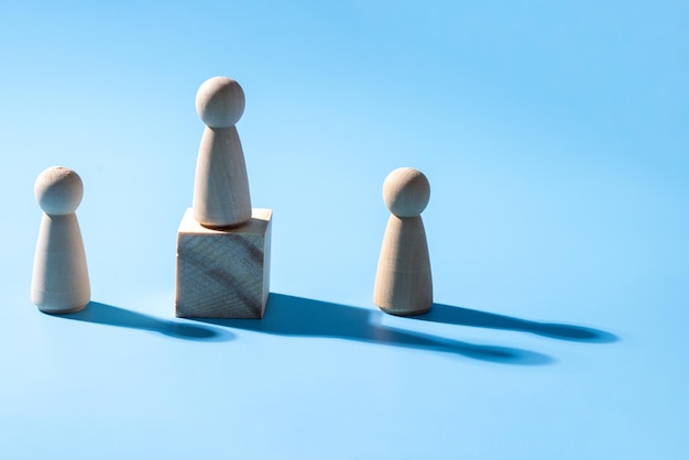 A wooden business teamwork symbol Leadership styles concept of strategy cooperation A group of employee from the company The wooden symbol with light blue background Professional business group
