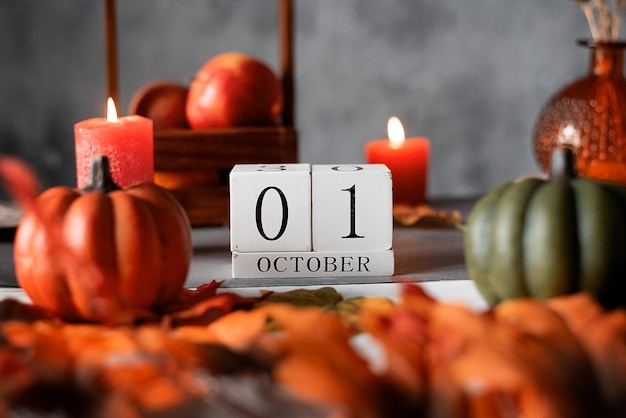 Wooden calendar 1 st october autumn decor apples candles and pumpkins