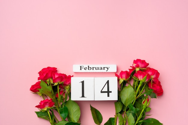 写真 2月14日木製カレンダーとピンクのバラ