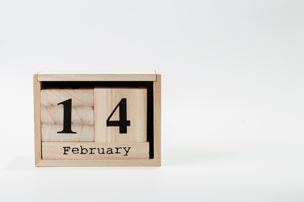 Wooden calendar February 14 on a white background