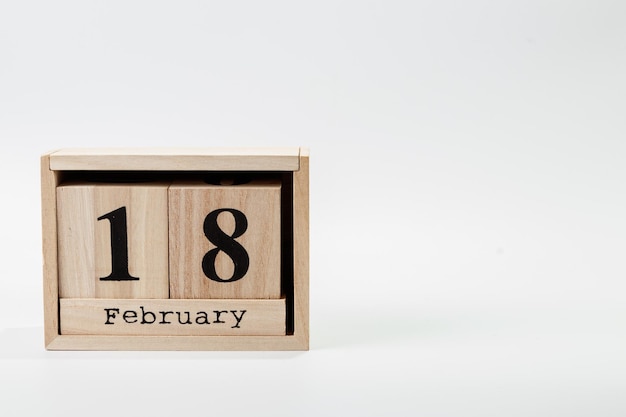 Wooden calendar February 18 on a white background