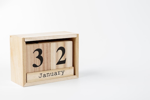 Фото Деревянный календарь 32 января на белом фоне