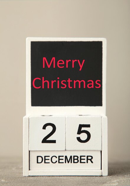 Wooden calendar set on the 25 of December Merry christmas